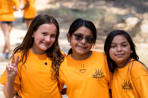 Three girls smile while at Angel Tree camp. Your gift today can provide a life-changing experience like this for more children of prisoners.