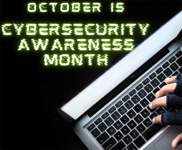 October is Cybersecurity Awareness Month - Photo: hand wearing fingerless gloves using laptop.