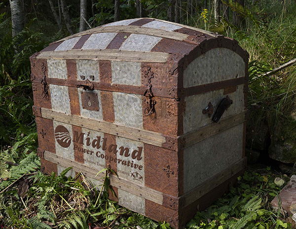 Old fashioned trunk with Midland logo sitting in the woods