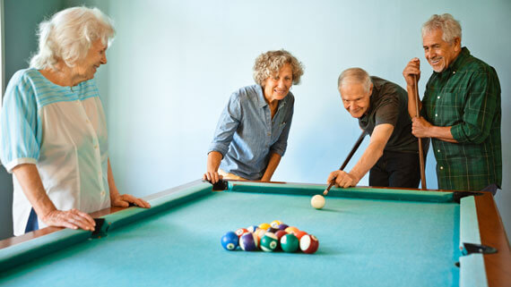 Group of seniors playing billiards