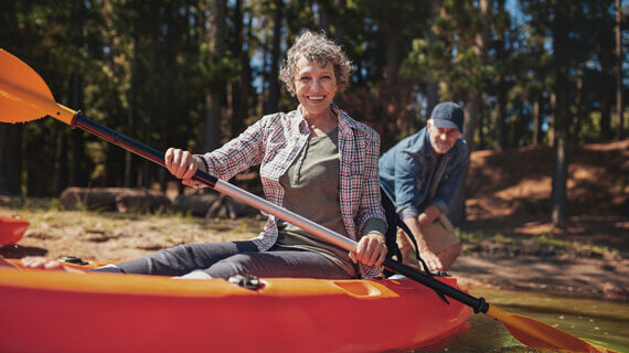 Senior couple out canoeing on the lake