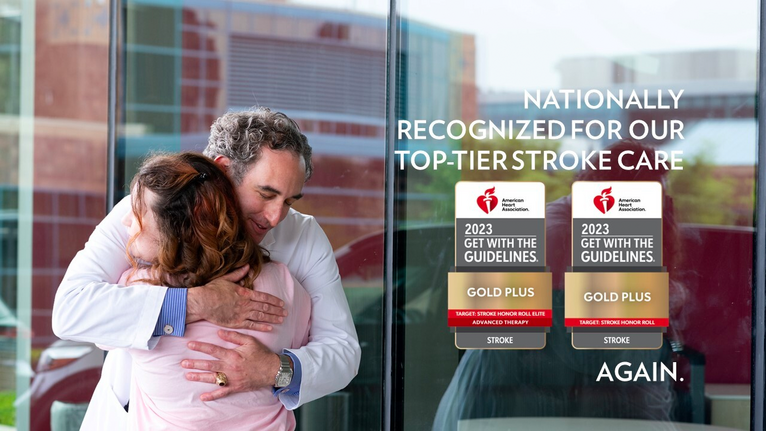 Two people hugging with images of the American Heart Association and American Stroke Association awards