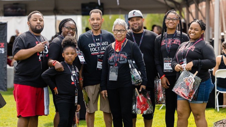 family smiling at a Bearcats on the Road event