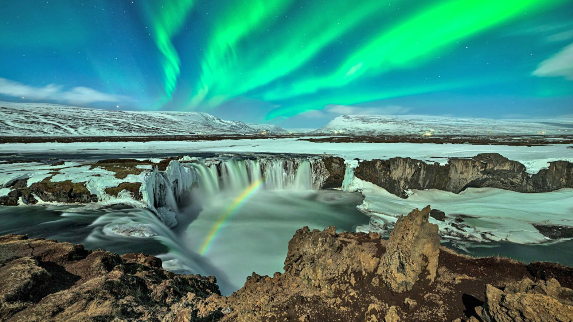 Northern Lights over a waterfall in Iceland