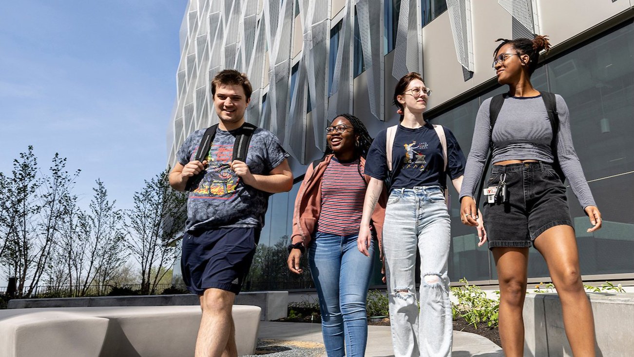 students walking across campus while talking