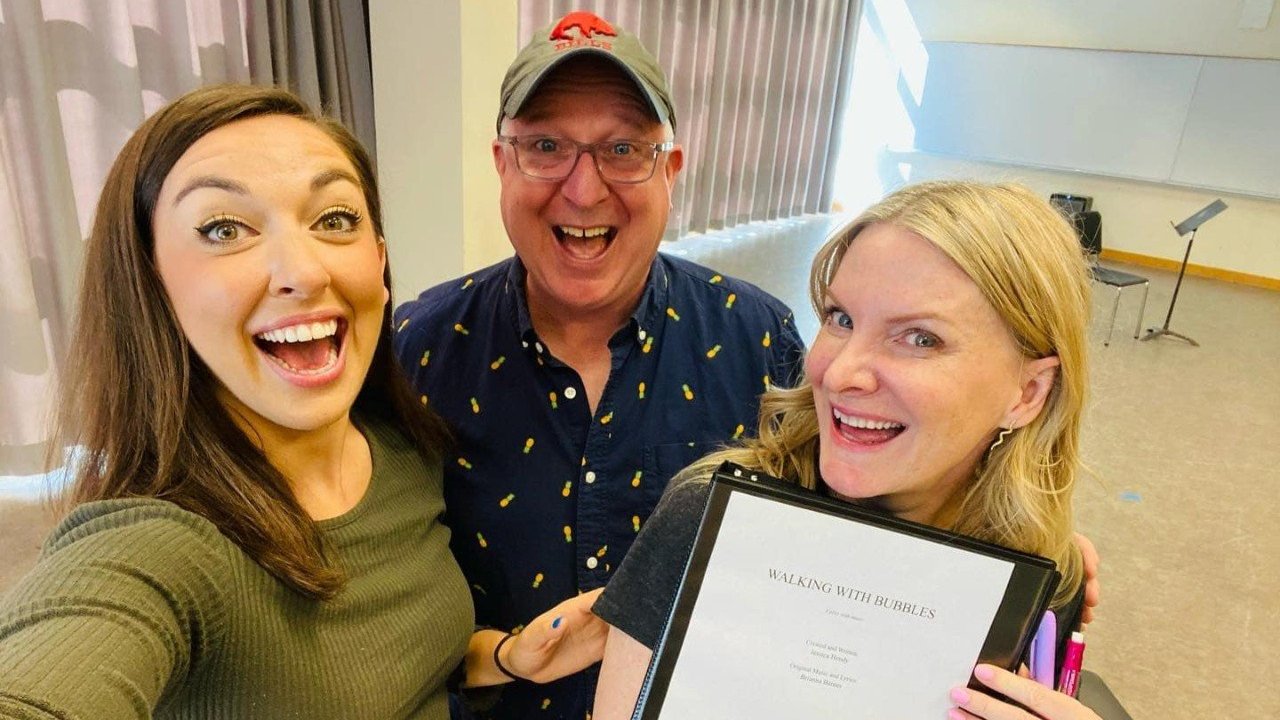 Brianna Barnes, Richard Hess and Jessica Hendy holding the ''Walking with Bubbles'' script