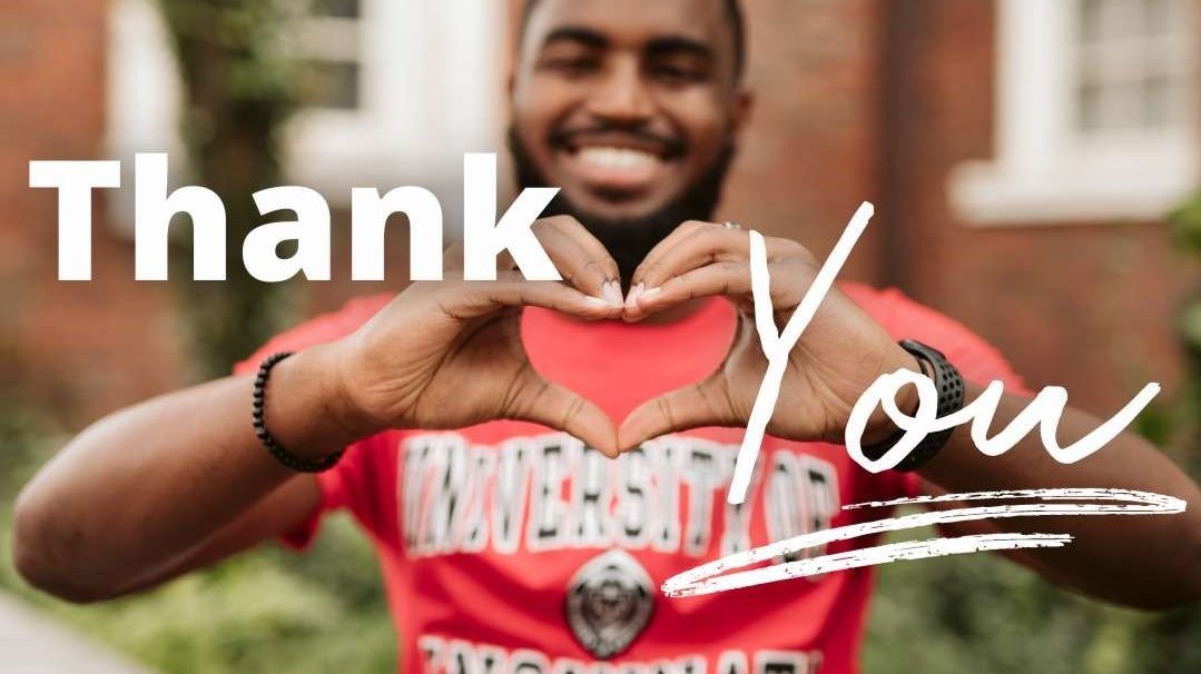 student making a heart with their hands with the words ''thank you''