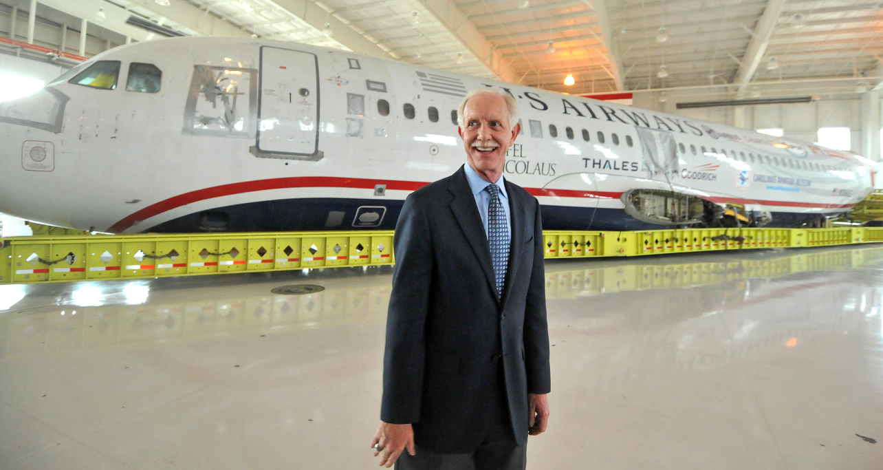 Sully in front of US Airways airplane