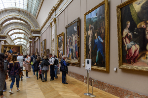 Visitors in a museum viewing paintings