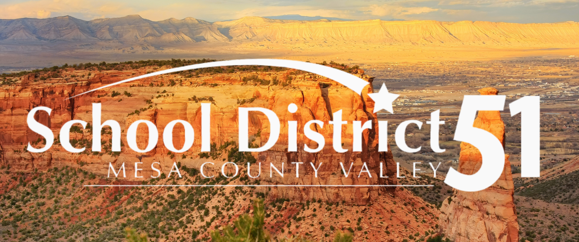School District 51 Mesa County Valley logo with shooting star over a photo of Colorado National Monument