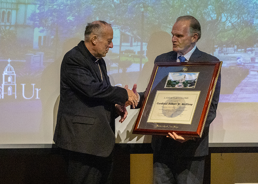 President Harris presents Cardinal McElroy with a Laudato si' fellows award