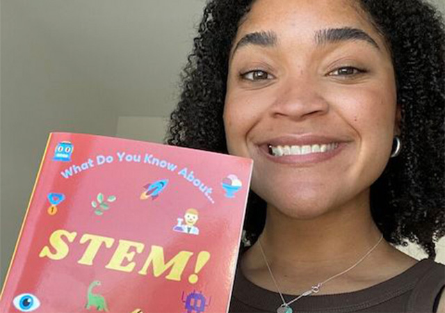 Image of Taylor Brown with a books she wrote about STEM