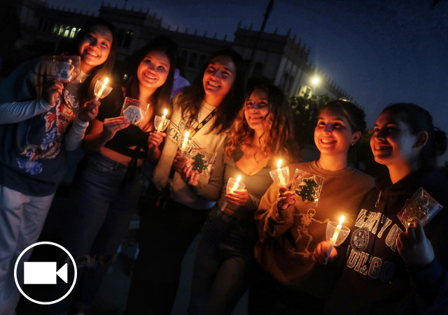 Image of a group of students holding candles at the USD Christmas Tree lighting