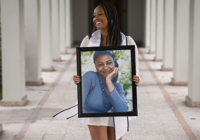 Kanuri Roundtree holds a photo of her late mother