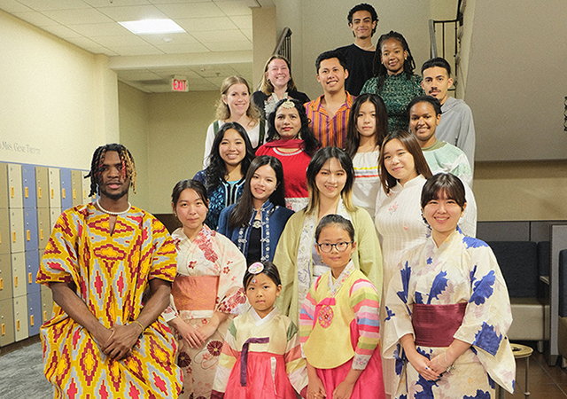 Students gather for a photo during the fashion show