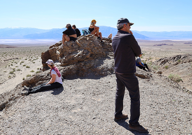 Students sitting in Death Valley while conducting research