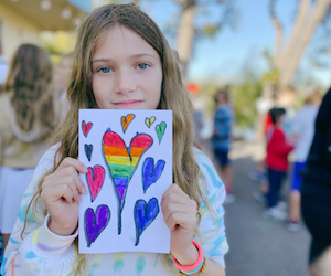 Child with heart drawing