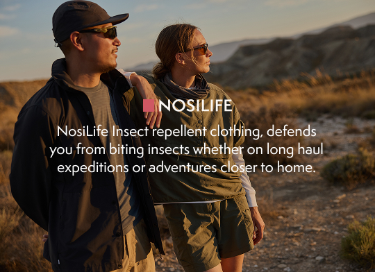 Two people looking into the distance as the sun sets.