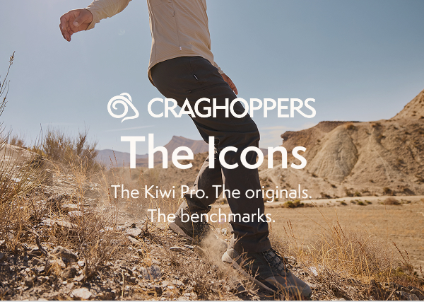 An image focusing on a person wearing walking pants in a dry/dusty desert setting