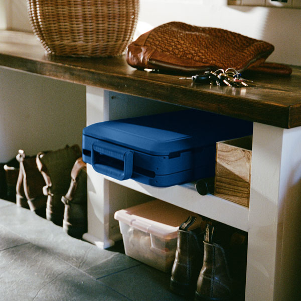 A cooler packed up and placed on a shelf.