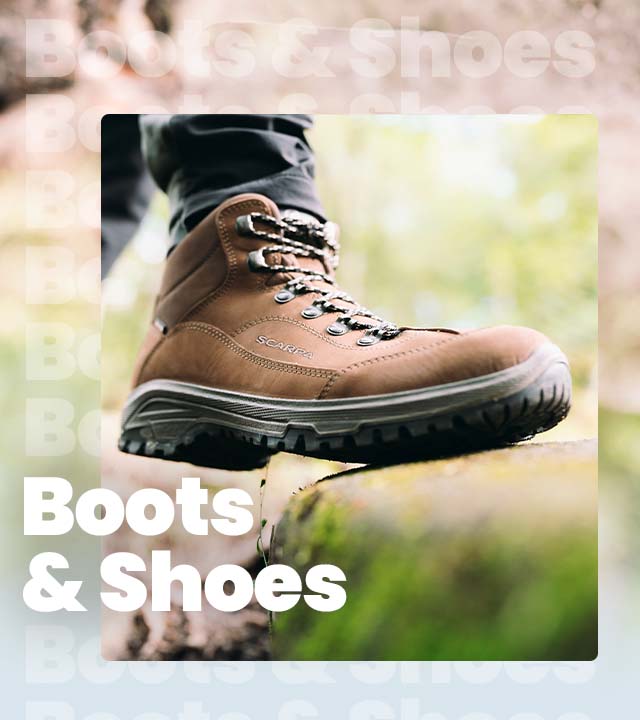 Person wearing hiking boots stepping on a rock