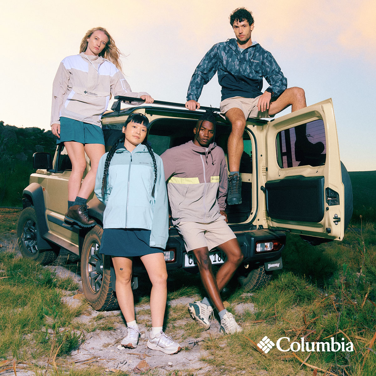 A group of people sitting out of the back of a truck in the mountains