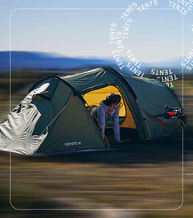 Woman peering out of a backpacking tent