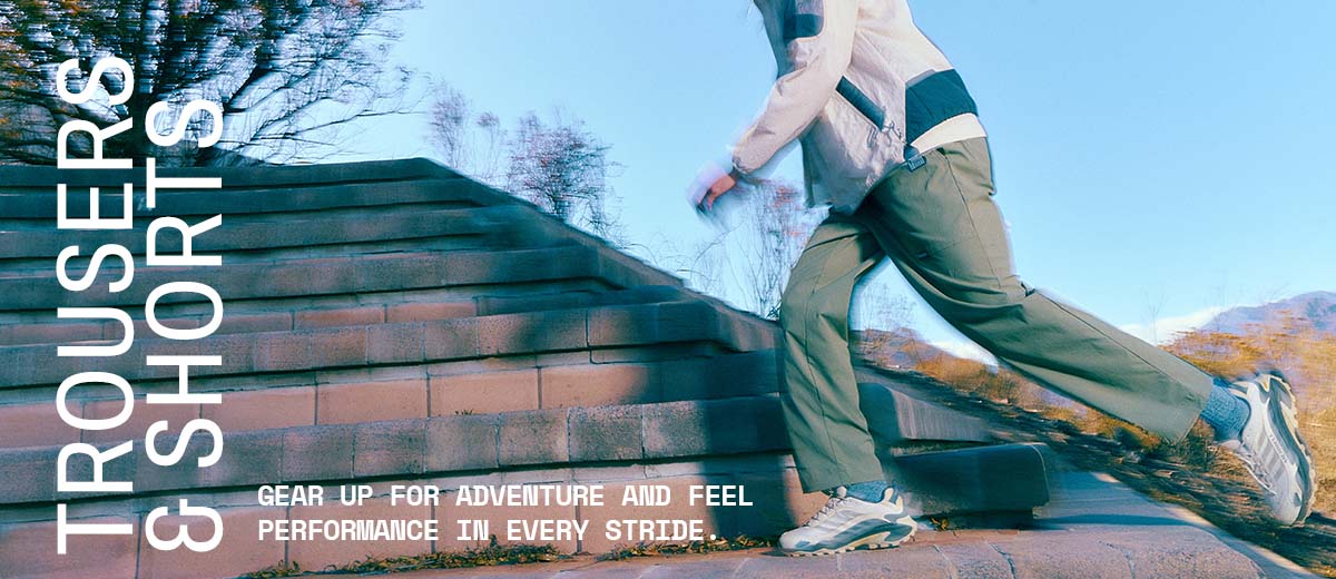 Close up image of a man wearing trousers and a jacket, walking up stairs