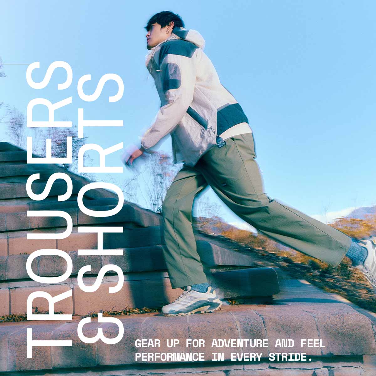 Close up image of a man wearing trousers and a jacket, walking up stairs