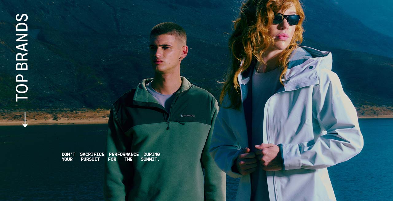 Woman and Man looking into the distance wearing a lightweight jacket and fleece