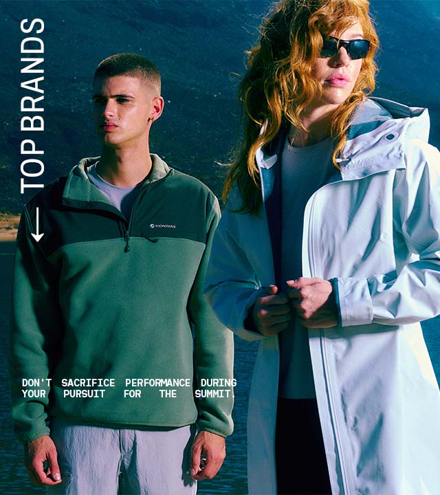 Woman and Man looking into the distance wearing a lightweight jacket and fleece