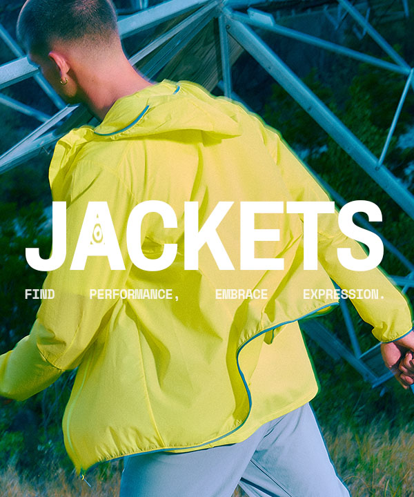 Man walking away, wearing a bright yellow windbreaker jacket