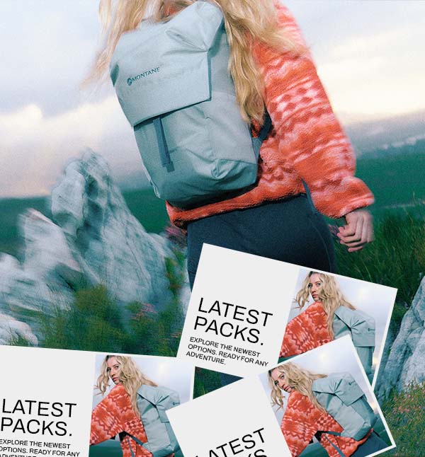 Hiker walking up a mountain carrying a backpack