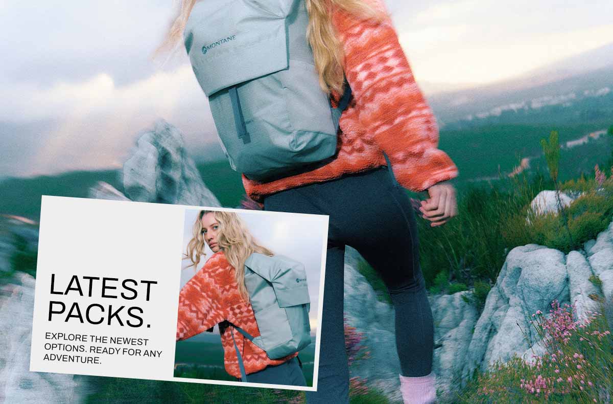 Hiker walking up a mountain carrying a backpack