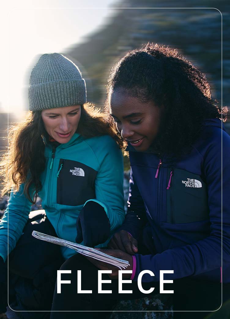 2 Women wearing TNf fleeces reading a map 