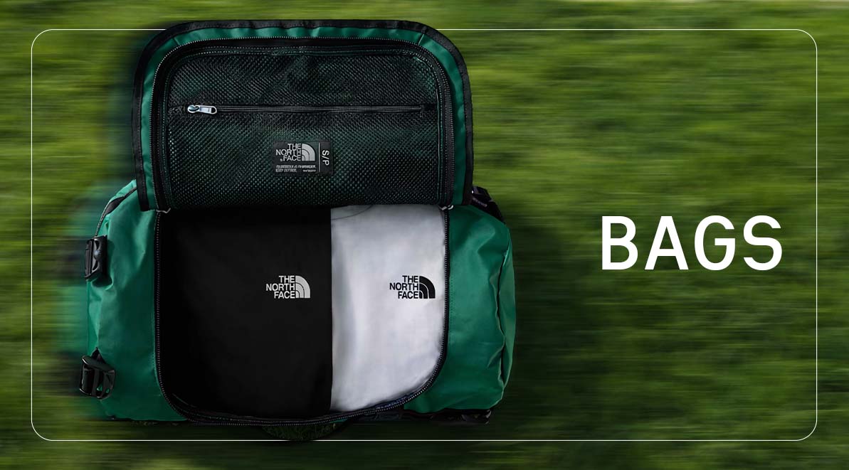 TNF duffle bag laying on grass