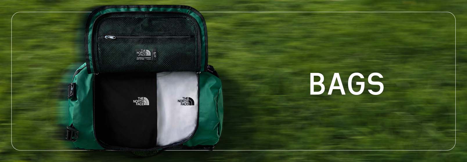 TNF duffle laying on grass