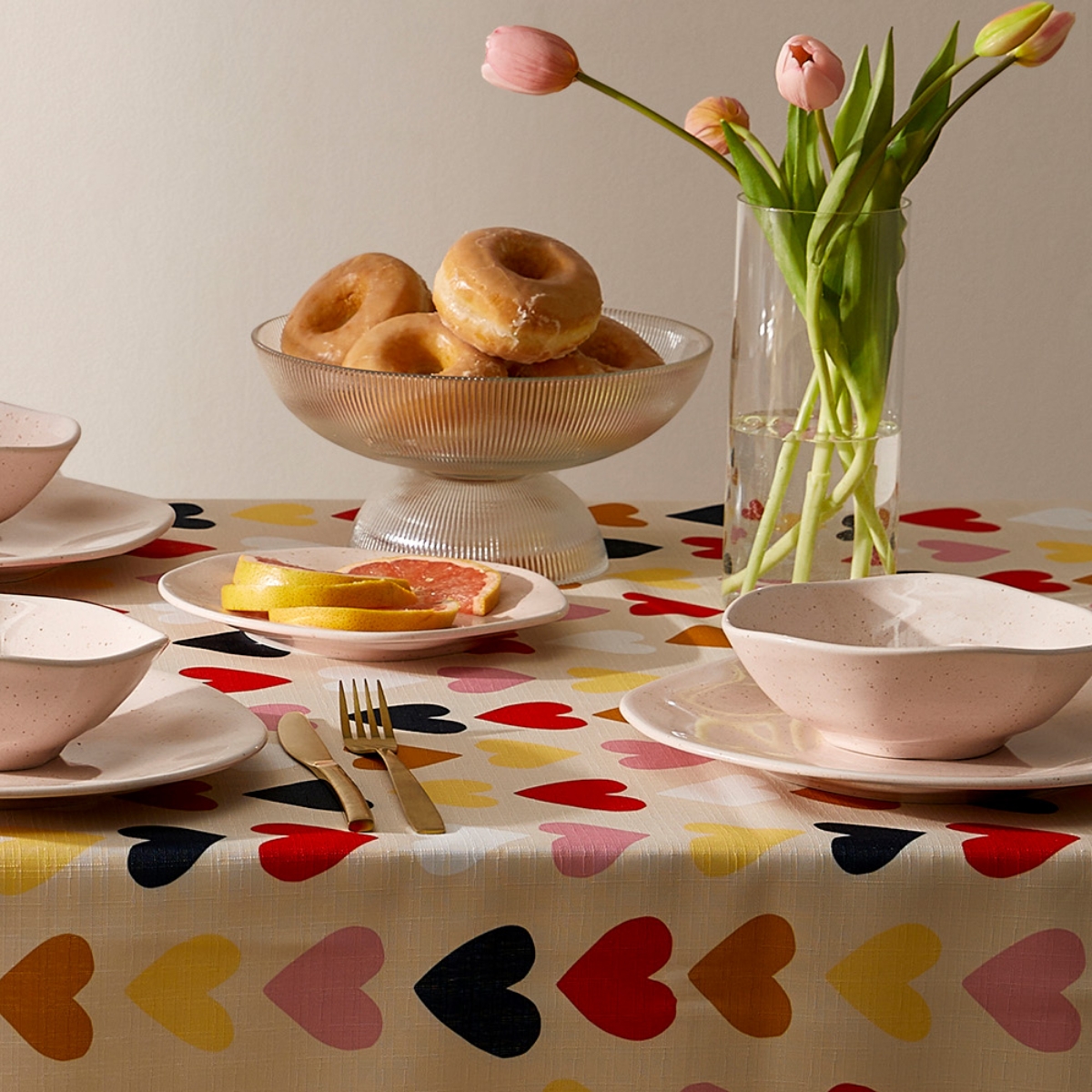 A pretty table decorated with a tablecloth embellished with colorful hearts 