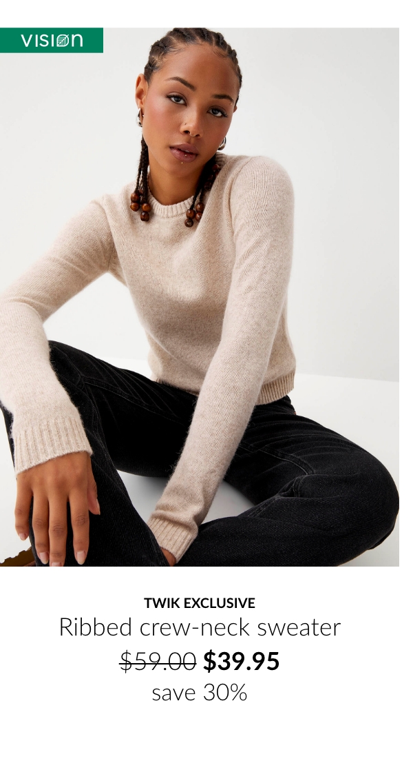 Young woman wearing a beige round neck sweater at  $39.95 instead of $59