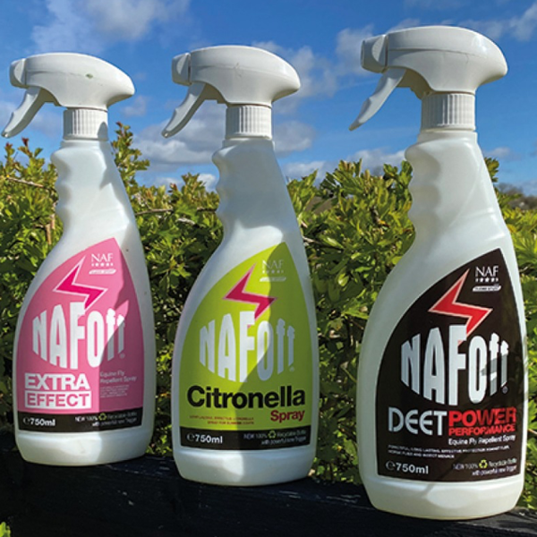 Three bottles of NafOff Spray against a backdrop of greenery and clear blue skies.