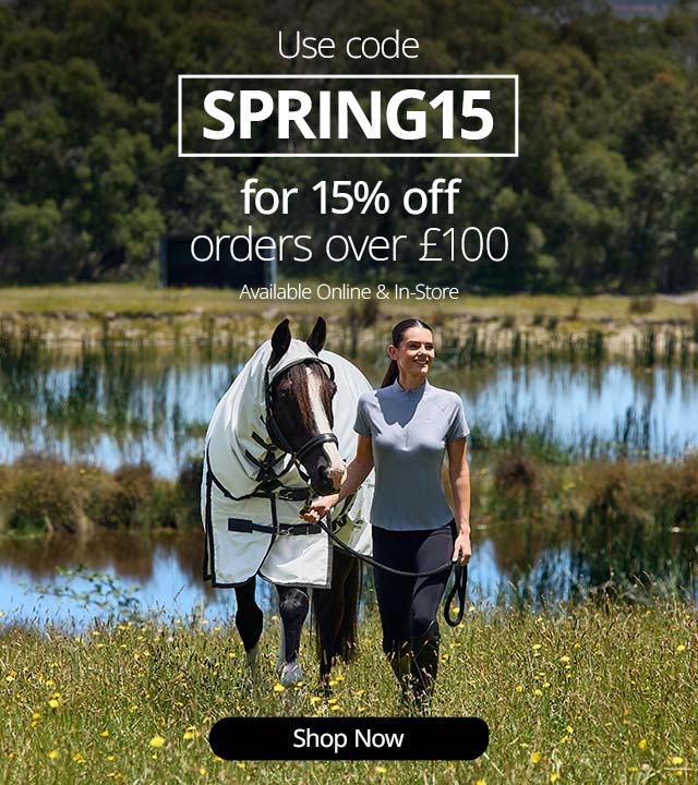 Promotional banner showing a person leading a horse wearing a white fly rug beside a lake, with text offering 15% off using code ‘SPRING15’ on orders over £100 and a ‘Shop Now’ button.