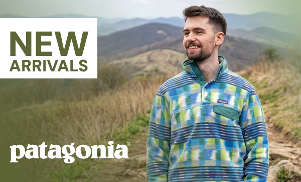 NEW ARRIVALS: PATAGONIA. A man walking in the hills, wearing Patagonia Men's Lightweight Synchilla Snap-T Pullover in Blue/Green
