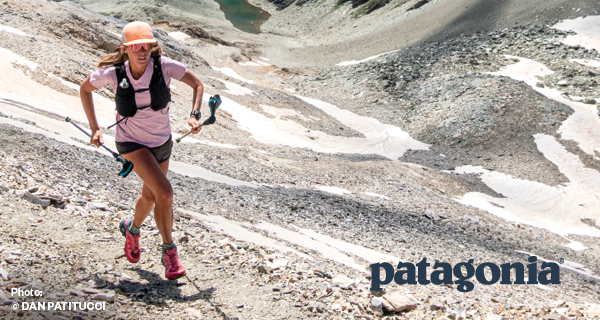 PATAGONIA. A woman runs through a rocky valley. 