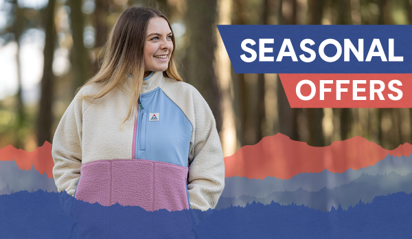 SEASONAL OFFERS: A woman in a forest wearing Passenger Women's Home 1/2 Zip Sherpa Fleece in Cream. 