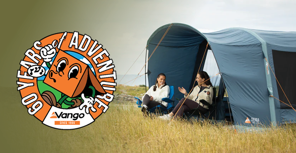 VANGO: 60 YEARS OF ADVENTURE. Two women sit in the porch of a Vango Sierra 300 Poled Tent. 