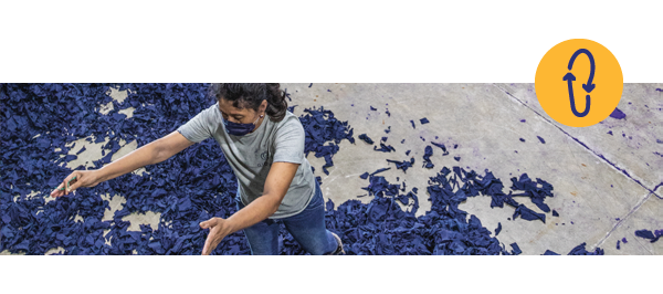 A woman sorts through textile scraps. On the right, two blue arrows form a circle within a yellow circle. 