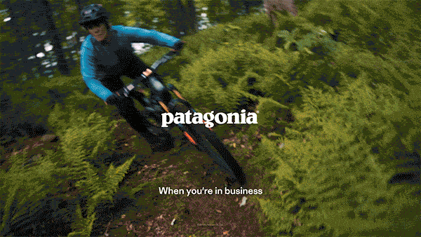 PATAGONIA: INNOVATION UNUSUAL. A short gif. A woman cycles along a trail, two people cartwheel down a sand dune, a woman climbs a cliff face, and two men build clothes. 