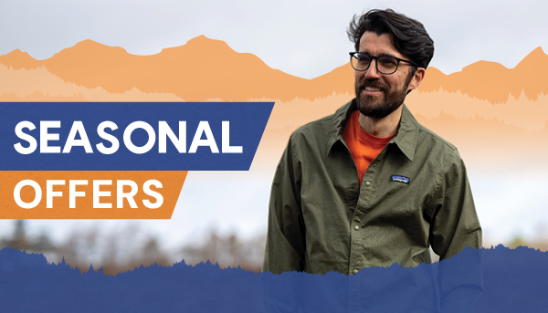 SEASONAL OFFERS: A smiling man wearing Patagonia Men's Lightweight All-Wear Unlined Jacket in Green.