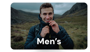 MEN'S. A man smiles at the camera, wearing a Rab Men's Microlight Alpine Down Jacket in Beluga/Dark Navy. 