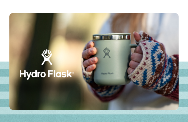 HYDRO FLASK. A woman in a forest, holding a 12oz Hydro Flask Mug.